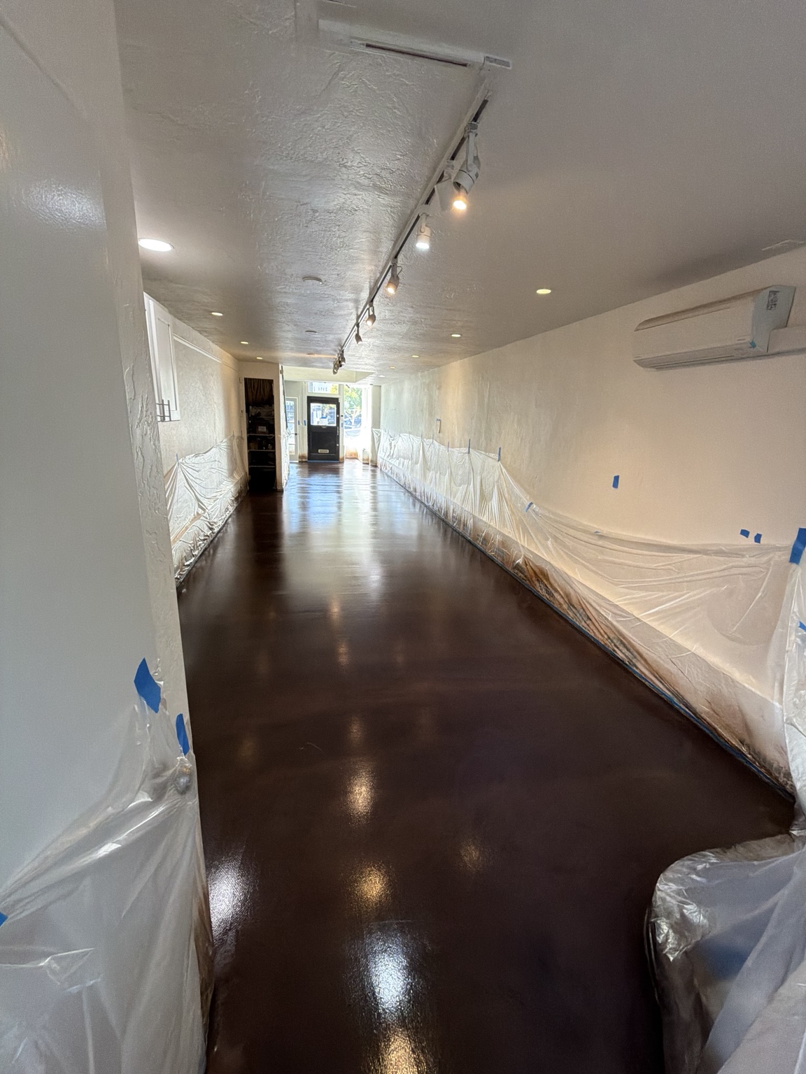 Deep brown stained commercial concrete floor by DCR